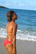 A girl stands near the Caribbean shore, just down the hill from Mount Victory Camp.