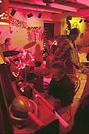 Three jazz musicians play in a dramatically lit room at the Blue Moon Jazz Club, Frederiksted St. Croix