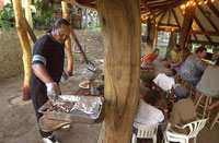 Ernest Toqruck serves food in the Mt. Victory pavilion.