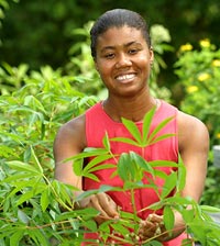 Mathilde tends plants in the garden