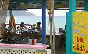 Several people relax in a St. Croix beach bar overlooking Cane Bay
