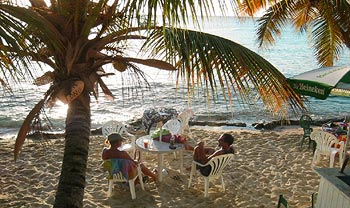 Sunset Grill restaurant at Sprat Hall Beach overlooks the western beach of St. Croix and features fine cuisine with tables right on the water's edge